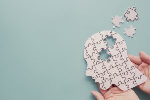 Hands,Holding,Brain,With,Puzzle,Paper,Cutout,,Autism,,Memory,Loss,